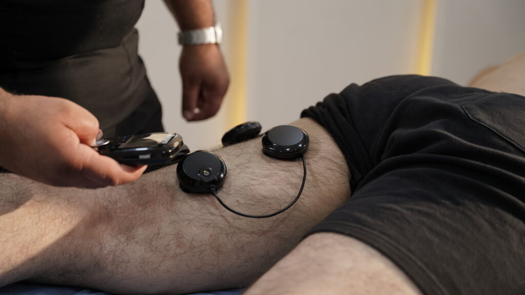 Physiotherapist guiding a patient through knee-strengthening exercises