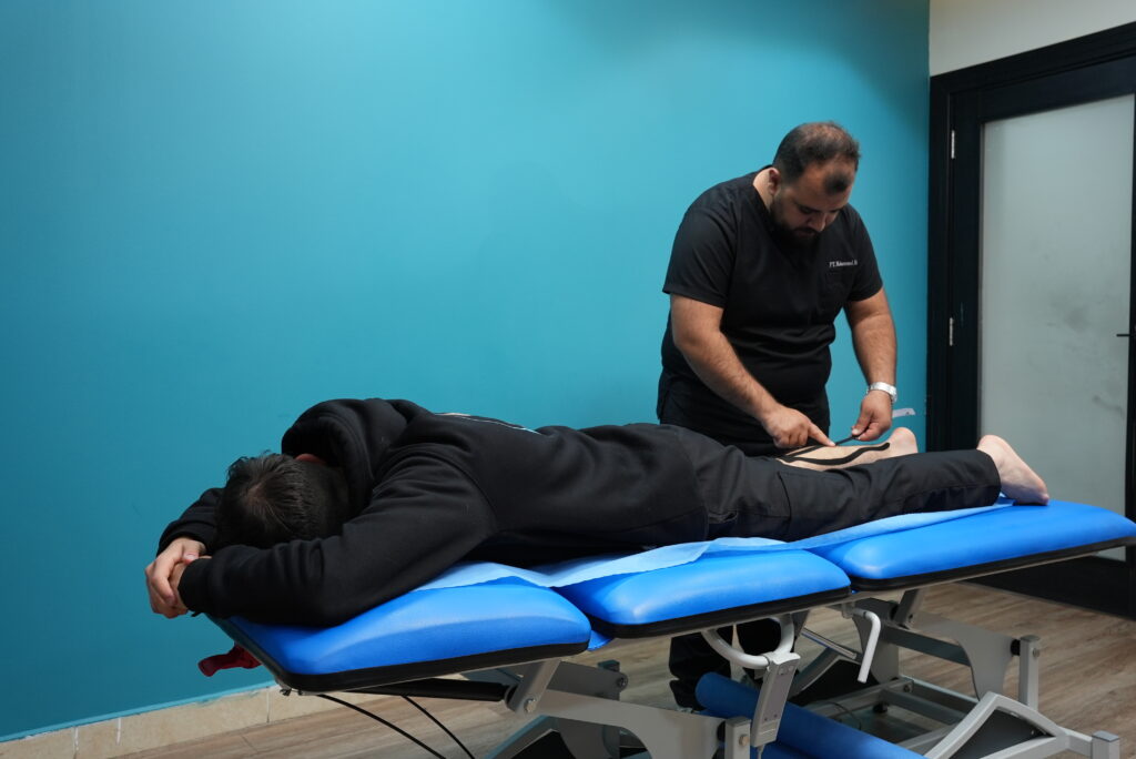 Physiotherapist demonstrating proper sitting posture to patient