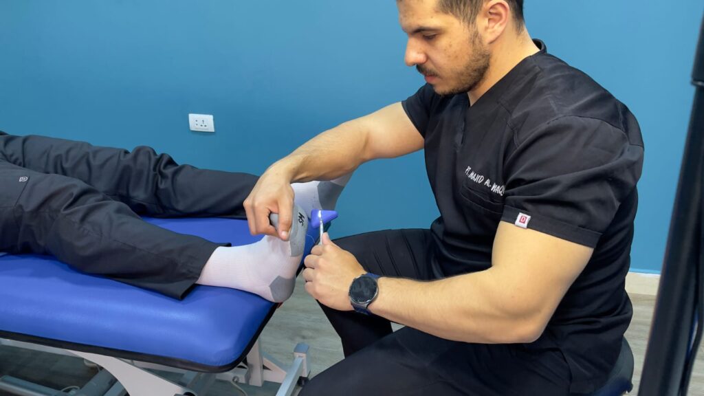 Physiotherapist examining a patient's foot for metatarsal pain
