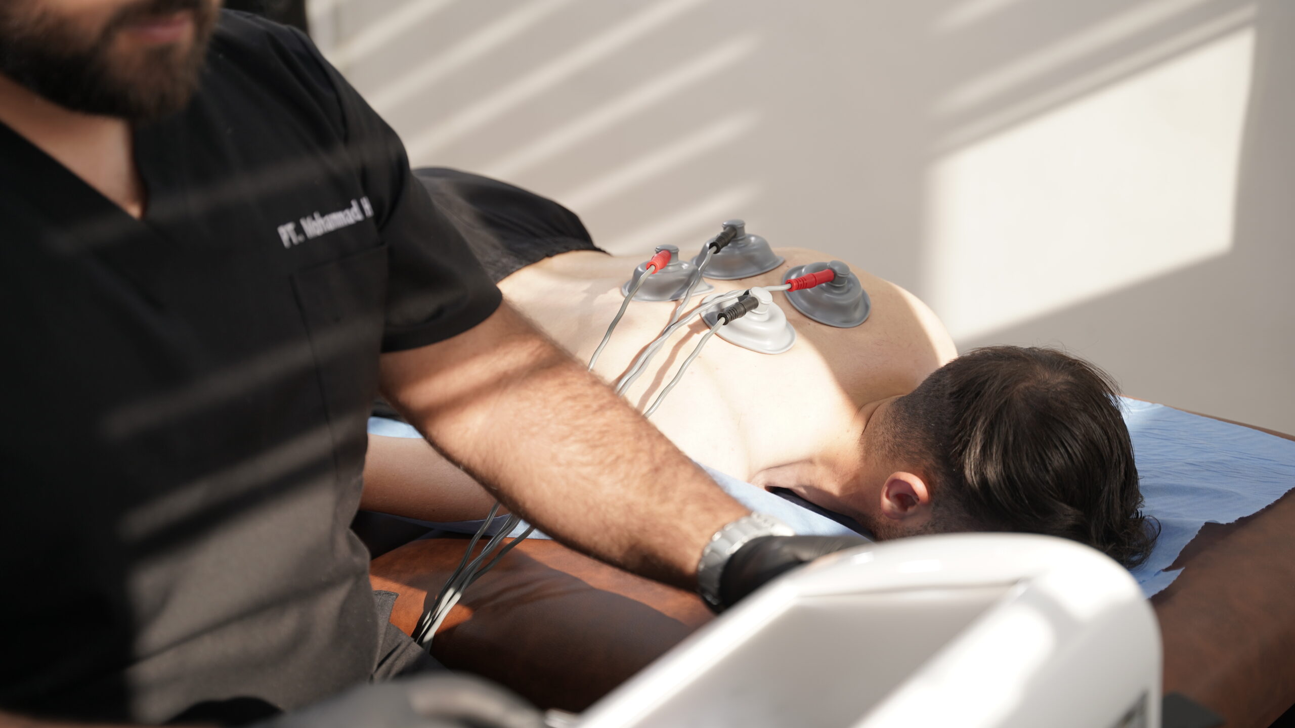 Close-up of physiotherapist applying deep tissue massage to rhomboid muscles